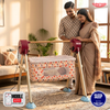 Couple standing with a baby crib in a living room, with 'Tinytyke' branding visible.