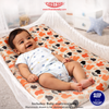 Baby lying on a colorful mattress with TINY TYKE branding.