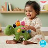 Child playing with TinyTyke — Plush Baby Dinosaur Soft Toy on a carpeted floor.