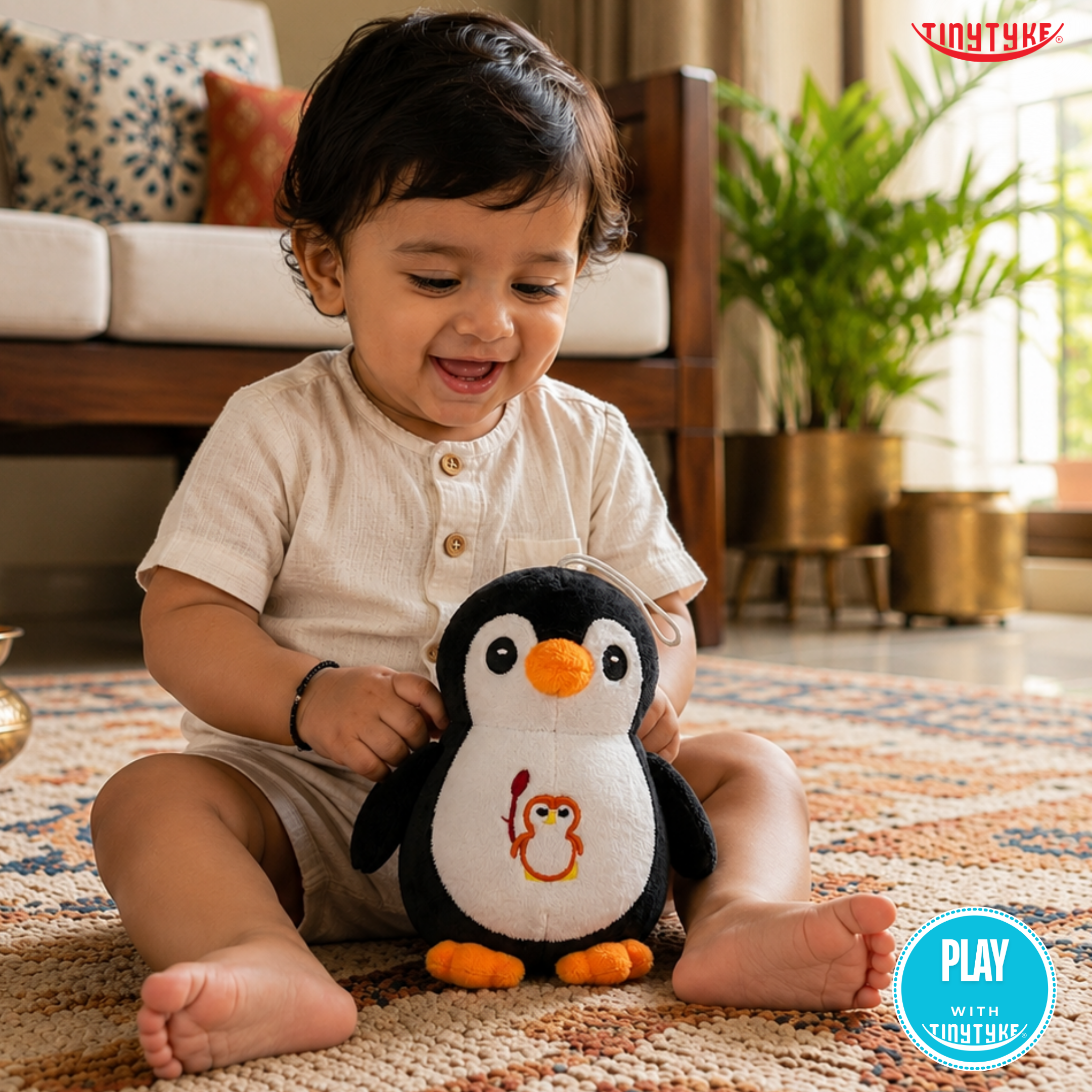 Child playing with TinyTyke — Plush Baby Penguin Soft Toy on a rug in a living room.