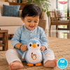 Child holding a TinyTyke — Plush Baby Penguin Soft Toy in a living room setting