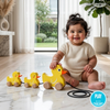 Baby playing with Wooden Pull-Along Duck Toy on a marble floor, with a blurred outdoor view in the background.