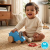 Child playing with a blue Wooden Pull-along Rabbit Toy on a rug, with a TINY TYKE logo in the corner.